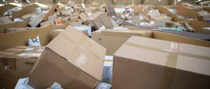 Pakete liegen in einem Paketzentrum von DHL. 