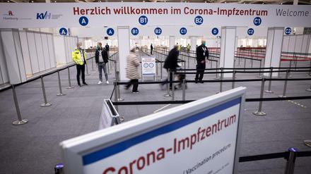 Zwei Senioren (M) sind im Eingangsbereich des Corona-Impfzentrums in den Hamburger Messehallen auf dem Weg zur Impfung. Dort erfolgt das Gros der Hambuger Corona-Schutzimpfungen.