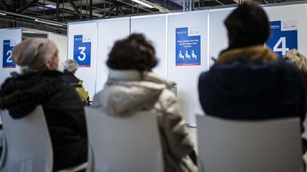 Personen warten auf eine Corona-Impfung im Impfzentrum in Schoenefeld.