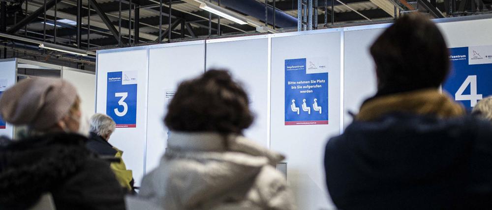 Personen warten auf eine Corona-Impfung im Impfzentrum in Schoenefeld.