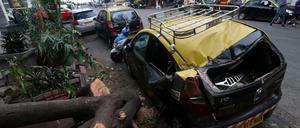 Ein beschädigtes Fahrzeug neben einem umgestürzten Baum nach starken Winden, die durch den Zyklon Tauktae in Mumbai, Indien, verursacht wurden.