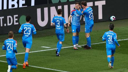 Kiels Abwehrspieler Simon Lorenz feiert mit seinen Mannschaftskameraden das 1:0.
