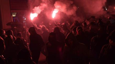 Vermummte Demonstranten bei einem Protestzug.