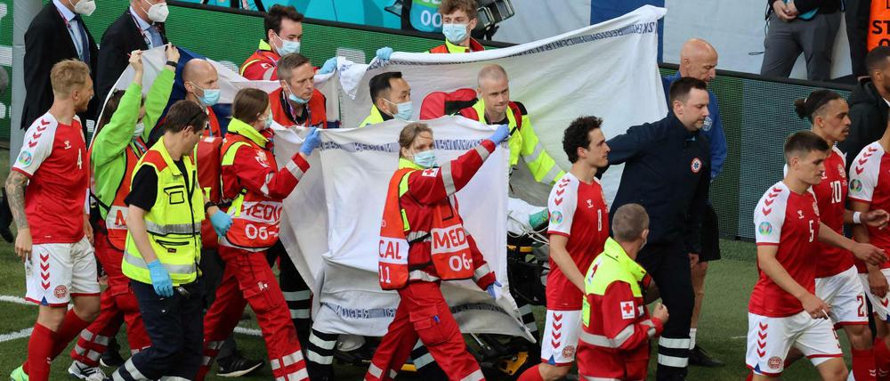 Der Spieler Christian Eriksen wird vom Platz getragen.