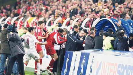 Die Schweizer Spieler (rote Trikots) flüchten nach dem Abpfiff in die Kabinen. 