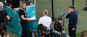 Nächste Frage, Basti. Jessy Wellmer und Bastian Schweinsteiger. Joachim Löw (Mitte) hört zu. 