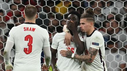 Mitspieler trösten Bukayo Saka nach dem verschossenen Elfmeter. 