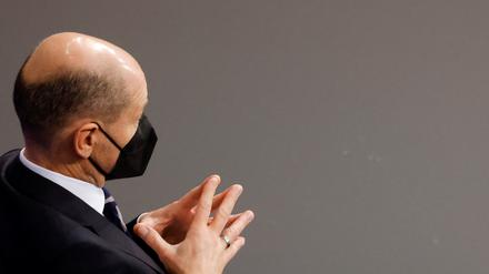 German Chancellor Olaf Scholz gestures as he sits at the end of a plenum session at the German lower house of parliament Bundestag, in Berlin, Germany, December 15, 2021. REUTERS/Michele Tantussi