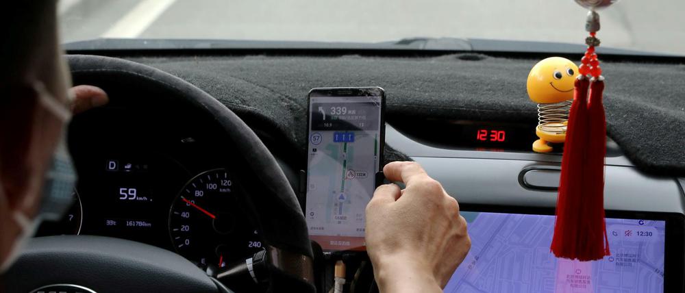 Ein Fahrer in Peking nutzt die App des Fahrdienstleisters Didi, der ins Kreuzfeuer der chinesischen Aufsichtsbehörden geraten ist.