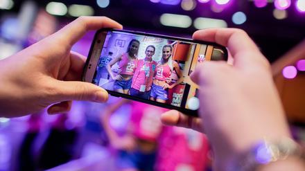 Influencerinnen mit einem jungen Fan an einem Messestand in Köln. 