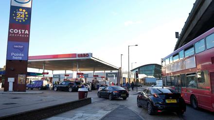 Autofahrer stehen an einer Tankstelle in einer Schlange, um zu tanken.