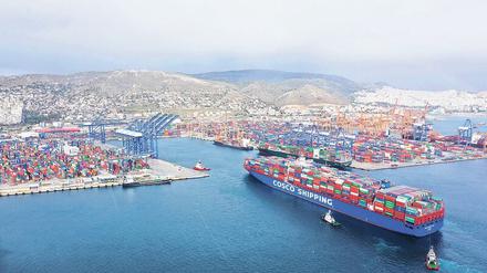 Stück für Stück die Welt erobern. Das chinesische Staatsunternehmen Cosco hat die größte Frachterflotte der Welt. Ein Containerfrachter fährt hier in den Hafen von Piräus ein, der zu einem Teil von Peking aufgekauft wurde. 