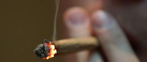 Ein Mann raucht im Coffee Shop einen Joint mit Marihuana. Die Sondierungen zur Ampel-Koalition könnten auch in Deutschland eine Entkrimininalisierung bewirken.