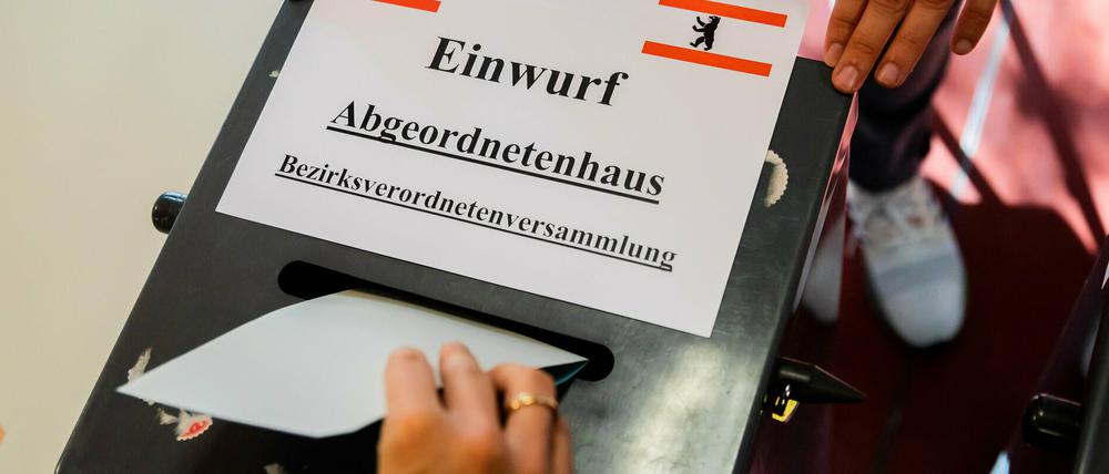 Eine Wählerin wirft ihre Stimmzettel für das Berliner Abgeordnetenhaus und die Bezirksverordnetenversammlung in die Urne.