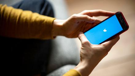 Auf dem Bildschirm eines Smartphones sieht man das Logo der App Twitter.