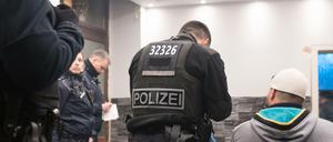  Beamte der Berliner Polizei, Zoll und Ordnungsamt durchsuchen ein Café. 