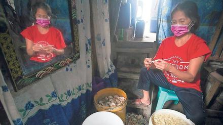Ätzende Arbeit. Für einen ganzen Sack Knoblauch benötigt Marites Arendain (Bild oben) acht Stunden und erhält dafür lediglich 1,67 Dollar.