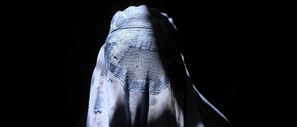 An Afghan woman wearing a traditional burkha