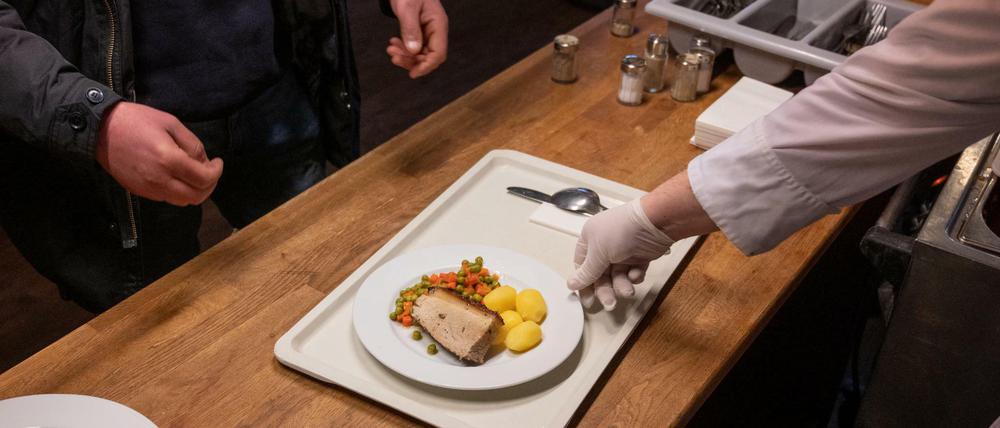 Im Hofbräuhaus Berlin wird an der Essensausgabe eine Mahlzeit ausgegeben. Das Hofbräuhaus hat momentan für Obdachlose geöffnet und verteilt von 10 bis 16 Uhr warme Mahlzeiten.