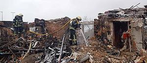 Feuerwehrleute in einem zerbombten Haus in Charkiw.