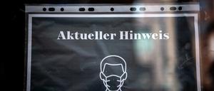 Ein Schild an einem Restaurant informiert über die FFP-2 Maskenpflicht. 