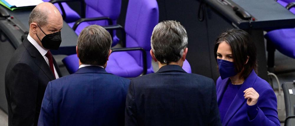 Bei einer Sitzung des Deutschen Bundestag sprechen Bundeskanzler Scholz und Außenministerin Baerbock mit Rolf Mützenich und Armin Laschet. 