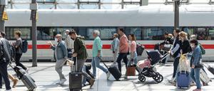 Reisende am Berliner Hauptbahnhof steigen aus einem Fernzug.