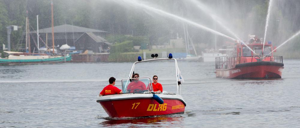 Wie praktisch, wenn die Feuerwehr für ein bisschen Erfrischung sorgt, oder? Hinten: Berlins Feuerwehrboot aus Spandau.