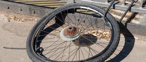 Nur noch das Hinterrad eines Fahrrads ist mit einem Fahrradschloss an das Geländer einer Berliner Brücke gekettet. 