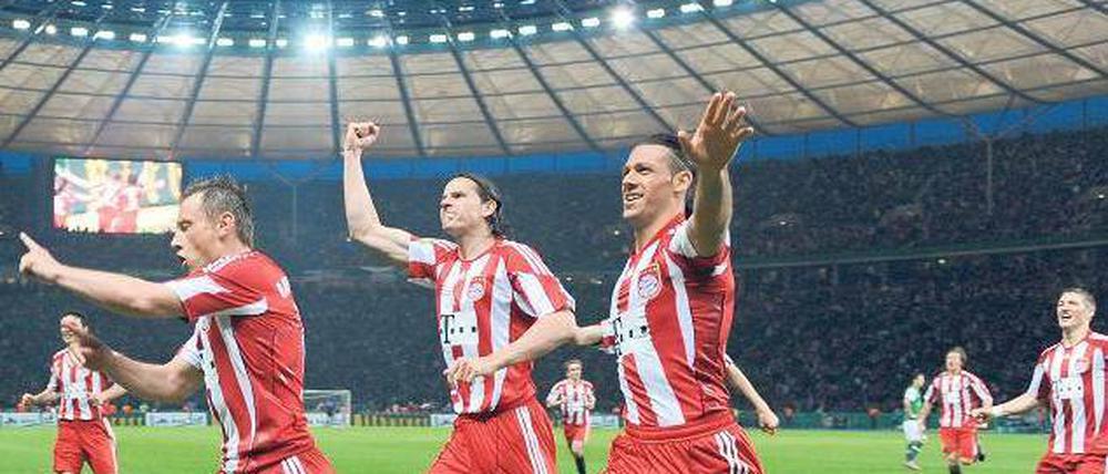 Zum Abheben. Die Bayern Ivica Olic, Daniel van Buyten und Martin Demichelis (von links) toben sich im Olympiastadion aus. Foto: dpa