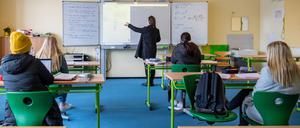 Eine Lehrerin und Schüler im Unterricht.