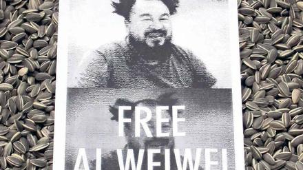 Wo ist Ai Weiwei? Ein Poster auf der Installation des Künstlers in der Londoner Tate Modern. Die Sonnenblumenkerne sind aus Porzellan, wie auch die ab Freitag in Berlin zu sehenden Werke.