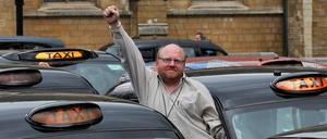 Ein Taxifahrer reckt am eine Faust in die Höhe während einer Protestkundgebung in London.
