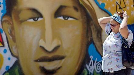 Ein Graffiti in Caracas zeigt den Staatschef Hugo Chavez. Dessen Gesundheitszustand verschlechtert sich zunehmend.