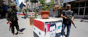 Regimetreu. Assad-Anhänger bewachen einen Kontrollpunkt in Damaskus.