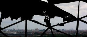 Blick aus dem Innern durch die in Teilen zerstörte Kuppel der NSA-Abhöranlage auf dem Berliner Teufelsberg auf das Panorama der Stadt.
