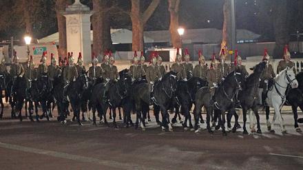 Angehörige des Militärs reiten auf der Mall vor dem Buckingham Palace im Zentrum Londons während einer nächtlichen Probe für die Krönung von König Charles III.