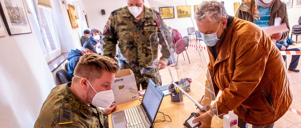 Ein Bundeswehrsoldat nimmt an der Anmeldung für die mobile Corona-Schutzimpfung auf der Ostseeinsel Poel die persönlichen Angaben eines Einwohners auf. Geimpft wird auf dem Freigelände des Inselmuseums in einem Krankenwagen mit Biontech-Impfstoff. Auf der Insel soll zusammen mit der Bundeswehr ein neues Konzept für Corona-Schutzimpfungen erprobt werden. Das Impfteam besteht aus einer Ärztin, einer medizinischen Fachkraft und vier Bundeswehrangehörigen. +++ dpa-Bildfunk +++