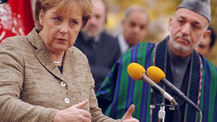 071103merkel_karsai