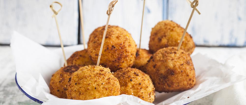 Arancini with skewers on a plate