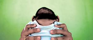 Jackeline, 26, holds her son who is 4-months old and born with microcephaly, in front of their house in Olinda, near Recife, Brazil, in this February 11, 2016 file photo. Evidence is building for the theory that Zika can cause newborn brain defects, and the World Health Organization is promising more answers in weeks, but nailing a definitive link will be neither simple nor swift. Picking apart numerous potential connections between mothers who show evidence of infection with the mosquito-borne virus and babies born with microcephaly, in which the head is abnormally small, will require precision and patience, specialists say. To match Insight HEALTH-ZIKA/MICROCEPHALY REUTERS/Nacho Doce/Files TPX IMAGES OF THE DAY