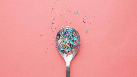 Environmental pollution and water microplastic. Micro plastic with spoon.