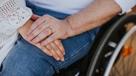 couple of lovers. Men using wheelchair in the park - happy couple