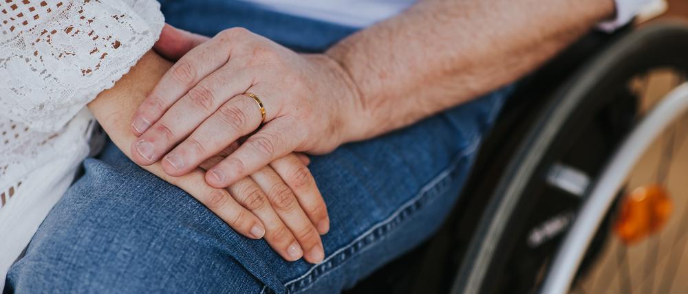 couple of lovers. Men using wheelchair in the park - happy couple