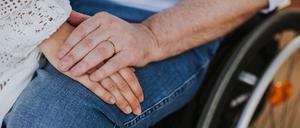 couple of lovers. Men using wheelchair in the park - happy couple