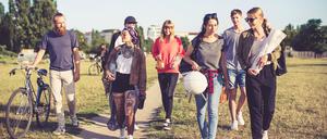 Multiracial friends going on picnic in city park