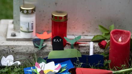 Kerzen und gebastelte Blumen liegen vor einer Stele an der Haupt- und Realschule Kaulbach-Schule im nordhessischen Bad Arolsen.