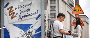 Menschen stehen in Moskau neben einem russischen Propagadaplakat. 