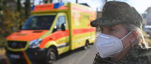 Eine Soldatin des Sanitätsdienstes der Bundeswehr vor einem Krankenhaus.