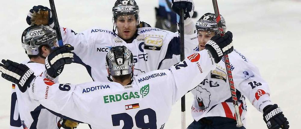 Berlins Jens Baxmann (M.) feiert seinen Treffer zum 2:0 gegen die Hamburg Freezers mit seinen Mitspielern.